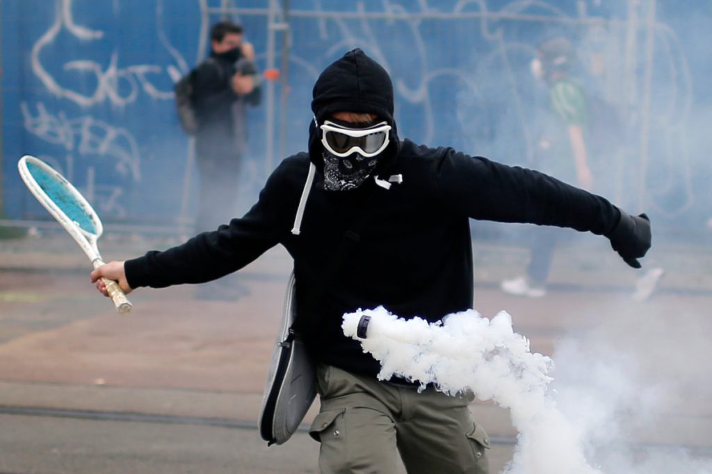 a-protestor-uses-a-tennis-racket-to-bounce-a-tear-gas-canister-during-a-demonstration-to-protest-the-governments-proposed-labor-law-reforms-in-nantes-france-on-june-2